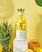 Bottle filled with pineapple chunks on a yellow background